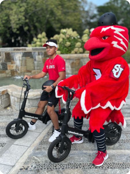 Student and mascot on e-bikes